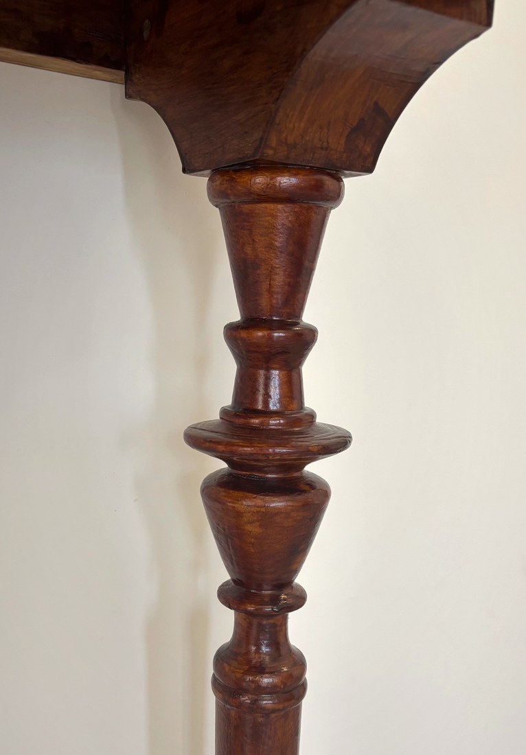 Carved corbel and layered turnings on the classic foyer table leg