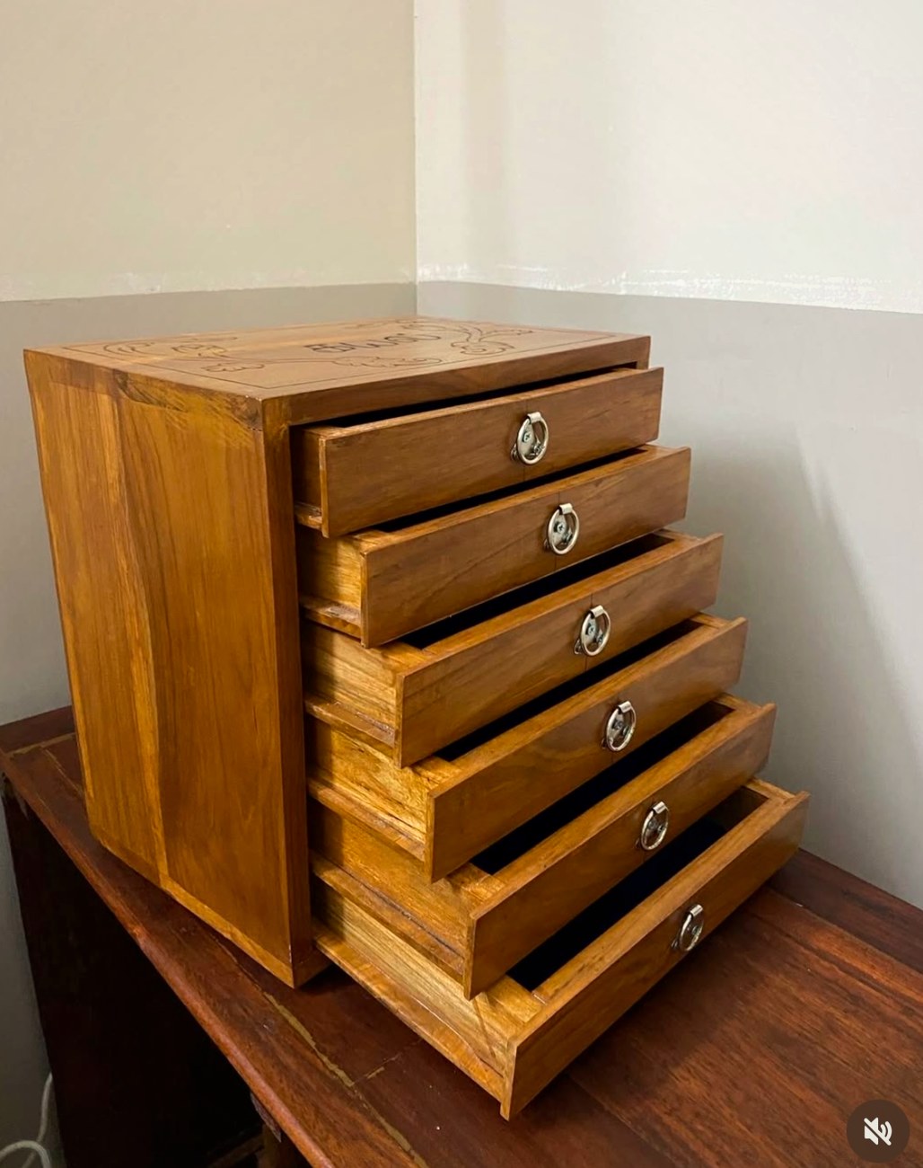 The chest seen from the side with its drawers stepped open