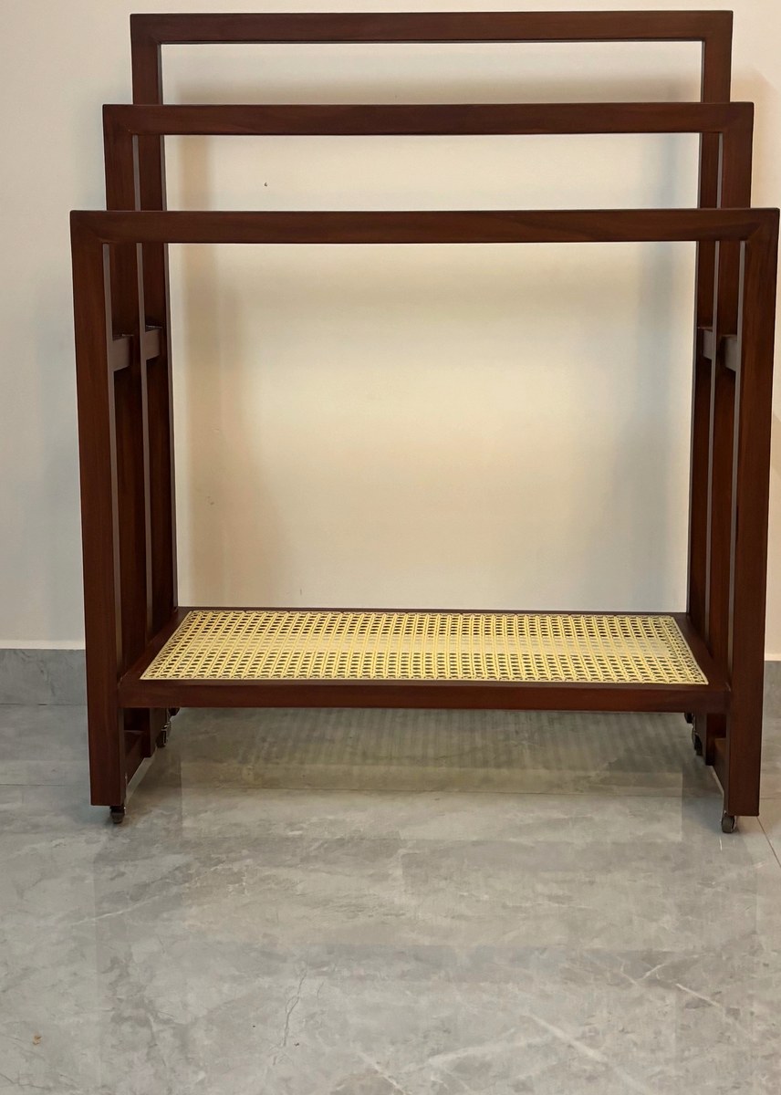 Teak towel stand with three rails and a woven cane shelf